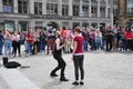 Group of people enjoying street performance at Dam Square, Amsterdam