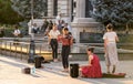 Group of people enjoying a sunny day on a city sidewalk in Bucharest, Romania.