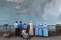 Group of people enjoying view of Niagara Falls, women in national clothes. Canadian side of Niagara Falls.
