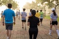 Group of people exercise in the park in morning.