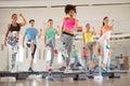 Group of people exercising on stepper Royalty Free Stock Photo
