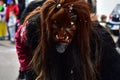 Group of people in festive masks participating in a traditional carnival parade in Deizisau, Germany