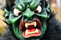 Group of people in festive masks participating in a traditional carnival parade in Deizisau, Germany