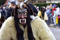 Group of people in festive masks participating in a traditional carnival parade in Deizisau, Germany