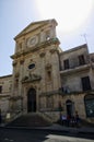 Group of people in the front of entrance of cathedral in Sicilian old City of Modica, Italy