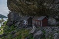 Group of people in front of wooden cottages under Helleren in Jossingfjord, Norway