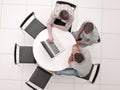 Group of people with gadgets sitting at a round table Royalty Free Stock Photo