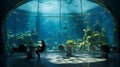 A group of people are gathered around a table in close proximity to a large aquarium tank