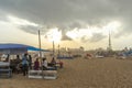 Group of people gathered at Marina beach,purchasing eatables from shops with dark sky scene during sunset time Royalty Free Stock Photo