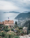 Group of people gathered in a verdant garden with the Mediterranean Sea, in Eze, France