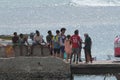 Group of people gathering on a pier on a sunny day in Sal Rei, Cabo Verde