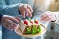 Group of people grabbing a piece of whole wheat sandwich to eat