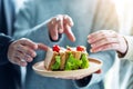 Group of people grabbing a piece of whole wheat sandwich in wooden plate