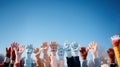 Group of people hands in warm knitted gloves raised up in winter on blue sky background Royalty Free Stock Photo