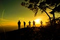 Group of people, Happy hiking standing on a cliff side with arms raised up