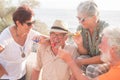 Group of people having fun together celebrating something happened - four seniors smiling and laughing at the beach Royalty Free Stock Photo