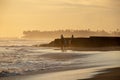 Group of people having horse riding adventure on sand sea beach