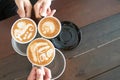 Group of people having a meeting after successful business negotiation in a coffee shop.Drinking hot beverage latte art coffee Royalty Free Stock Photo