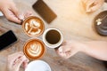 Group of people having a meeting after successful business negotiation in a coffee shop.Drinking hot beverage latte art coffee Royalty Free Stock Photo