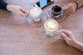 Group of people having a meeting after successful business negotiation in a coffee shop.Drinking hot beverage latte art coffee Royalty Free Stock Photo