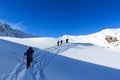 Group of people hiking on snowshoes and mountain snow panorama with blue sky in Stubai Alps Royalty Free Stock Photo