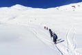 Group of people hiking on snowshoes and mountain snow panorama with blue sky in Stubai Alps Royalty Free Stock Photo