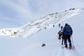 Group of people hiking on snowshoes and mountain snow panorama with blue sky in Stubai Alps Royalty Free Stock Photo