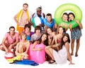 Group people holding beach accessories.