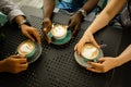 Group of people holding coffee cups, top view