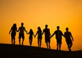 Group of People Holding Hands in Back lit Royalty Free Stock Photo