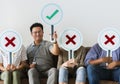 Group of people holding true & false icons