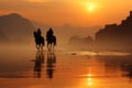 Group of people horse riding on the beach at sunrise. Foggy morning on a sandy beach Royalty Free Stock Photo