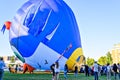 Group of people and hot air balloons on the ground during the European Balloon Festival