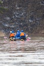 Group of people on the inflatable catamarans rafting on the river