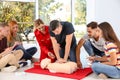 Group of people with instructor practicing CPR