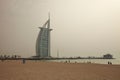 Group of people on the Jumeirah beach with the Burj Al Arab Hotel in the background Royalty Free Stock Photo