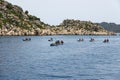 A group of people in kayaks travels near the Kekova Island. Tourists kayaking in the Mediterranean Sea Royalty Free Stock Photo