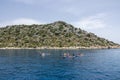 A group of people in kayaks travels near the Kekova Island. Tourists kayaking in the Mediterranean Sea Royalty Free Stock Photo