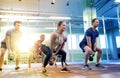 Group of people with kettlebells exercising in gym Royalty Free Stock Photo