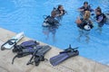 Group of people learn to scuba dive in a pool in Rarotonga Cook