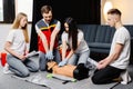 Group of people learning how to make first aid heart compressions with dummies during the training indoors Royalty Free Stock Photo