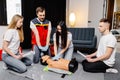 Group of people learning how to make first aid heart compressions with dummies during the training indoors Royalty Free Stock Photo