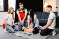 Group of people learning how to make first aid heart compressions with dummies during the training indoors Royalty Free Stock Photo