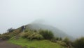 Group of people looking backwards walking towards the summit of the Rucu Pichincha volcano on a cloudy day, near the city of Quito