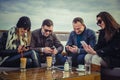 Group of people looking at a cell phone and laughing Royalty Free Stock Photo
