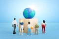 Group of people looking at earth model. Concept of environmental knowledge and sustainability Royalty Free Stock Photo