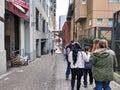 Group of people making their way down Post Alley past the gum wall in Pike Place Market