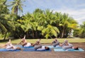 Group of people making yoga exercises outdoors