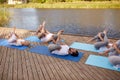 Group of people making yoga exercises outdoors