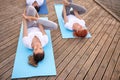 Group of people making yoga exercises outdoors